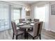 Bright dining area with round table, four chairs, and sliding glass doors at 6036 Mangrove Creek Rd, Wimauma, FL 33598