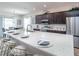 Modern kitchen with large island, white countertops, and stainless steel appliances at 6036 Mangrove Creek Orch, Wimauma, FL 33598