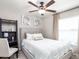 Bright bedroom with a queen-size bed and built-in shelving at 6042 Mangrove Creek Rd, Wimauma, FL 33598