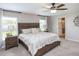 Large main bedroom with a wood bed frame and ensuite bathroom at 6042 Mangrove Creek Rd, Wimauma, FL 33598