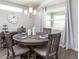 Dining area with gray wood table and six chairs at 6050 Mangrove Creek Road, Wimauma, FL 33598