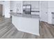 Modern kitchen island with granite countertops and white cabinets at 6068 Ballast Dr, Wimauma, FL 33598