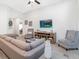 Living room features a fireplace and neutral colored furniture at 6081 Ballast Dr, Wimauma, FL 33598