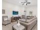 Bright living room with neutral decor and a cozy fireplace at 6081 Ballast Dr, Wimauma, FL 33598