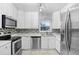 Kitchen with stainless steel appliances and white cabinets at 1411 Fernwood Pl, Seffner, FL 33584