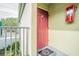 Inviting condo entry with a red door and a decorative welcome mat at 1799 N Highland Ave # 26, Clearwater, FL 33755