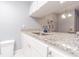 Well-equipped condo kitchen with granite countertops and white cabinets at 1799 N Highland Ave # 26, Clearwater, FL 33755
