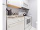 Condo kitchen boasts white appliances and granite countertops at 1799 N Highland Ave # 26, Clearwater, FL 33755