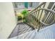 Exterior condo stairs with dark metal railings leading down to the courtyard at 1799 N Highland Ave # 26, Clearwater, FL 33755
