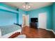 Bedroom with light blue walls, wood floors, and built-in shelving at 6011 Hammock Hill Ave, Lithia, FL 33547