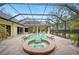 Inviting pool and spa with covered patio and string lights at 6011 Hammock Hill Ave, Lithia, FL 33547