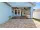 Covered back patio with brick pavers, ceiling fans, and access to the backyard at 9713 Royce Dr, Tampa, FL 33626