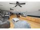 Large bonus room with hardwood floors, sectional sofa and big screen TV at 9713 Royce Dr, Tampa, FL 33626