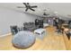 Spacious bonus room features hardwood floors, comfortable seating, and a large TV at 9713 Royce Dr, Tampa, FL 33626