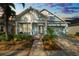 Light blue house with front porch, two-car garage, and landscaping at 9713 Royce Dr, Tampa, FL 33626