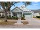 Two-story light blue house with front porch, landscaping, and a two-car garage at 9713 Royce Dr, Tampa, FL 33626