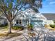 Light blue house with white columns, two-car garage, and manicured landscaping at 9713 Royce Dr, Tampa, FL 33626