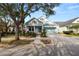 Two-story light blue house with front porch, landscaping, and a two-car garage at 9713 Royce Dr, Tampa, FL 33626
