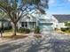 Light blue house with a two-car garage and manicured landscaping at 9713 Royce Dr, Tampa, FL 33626