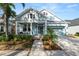 Charming two-story house with light blue exterior, landscaping, and a two-car garage at 9713 Royce Dr, Tampa, FL 33626