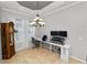 Bright home office features built-in desk, hardwood floors, and large windows at 9713 Royce Dr, Tampa, FL 33626