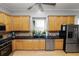 Modern kitchen with light wood cabinets, granite counters and stainless steel appliances at 9713 Royce Dr, Tampa, FL 33626