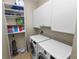 Laundry room with washer, dryer, shelving, and cabinets at 9713 Royce Dr, Tampa, FL 33626