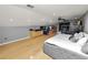 Main bedroom with large bed, home office, and hardwood floors at 9713 Royce Dr, Tampa, FL 33626