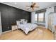 Large main bedroom with hardwood floors and an accent wall at 9713 Royce Dr, Tampa, FL 33626