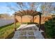 Wooden pergola with shade cover in backyard at 9713 Royce Dr, Tampa, FL 33626