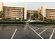 Exterior view of a condominium building with parking lot at 14900 Gulf Blvd # 113, Madeira Beach, FL 33708