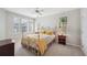 Bright bedroom with a white metal bed frame, neutral walls, and large windows with natural light at 2311 W Morrison Ave # 13, Tampa, FL 33629