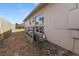 View of the side yard with a small deck and sliding glass doors at 3415 N 53Rd St, Tampa, FL 33619