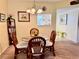 Simple dining area with glass table and wicker chairs at 936 Virginia St # 208, Dunedin, FL 34698