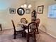 Bright dining area with glass table and four wicker chairs at 936 Virginia St # 208, Dunedin, FL 34698