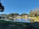 Serene community lake view with reflection of buildings and trees at 936 Virginia St # 208, Dunedin, FL 34698