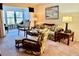 Living room features a comfy sofa, wicker furniture, and access to a sunroom at 936 Virginia St # 208, Dunedin, FL 34698