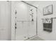 Sleek, modern bathroom featuring a glass-enclosed shower with white subway tile and a contemporary showerhead at 11658 Bluestone Ct, Parrish, FL 34219