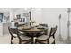 Cozy dining area with a round table, seating for four, and stylish décor at 11658 Bluestone Ct, Parrish, FL 34219