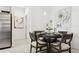 Elegant dining area featuring a round table with seating, modern lighting, and contemporary artwork at 11658 Bluestone Ct, Parrish, FL 34219