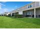 Exterior view of the back of a building with well-kept lawns and screened-in patios at 11658 Bluestone Ct, Parrish, FL 34219