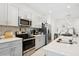 Well-equipped kitchen with stainless steel appliances, light gray cabinetry, and subway tile backsplash at 11658 Bluestone Ct, Parrish, FL 34219