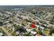 An aerial view showing a house with surrounding trees, and neighborhood at 2167 Timber Ln, Clearwater, FL 33763