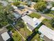 Aerial view of home featuring a big lawn, perimeter fence, and a quiet residential street at 2167 Timber Ln, Clearwater, FL 33763