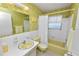 Retro bathroom featuring yellow fixtures, floral wallpaper, and a shower with a curtain at 2167 Timber Ln, Clearwater, FL 33763