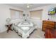 Cozy bedroom with a quaint quilt, wood dresser, and a table with a unique lamp at 2167 Timber Ln, Clearwater, FL 33763