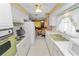 Vintage kitchen featuring white appliances, retro wallpaper, and a compact layout at 2167 Timber Ln, Clearwater, FL 33763