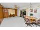 Spacious living room features paneled walls, ceiling fan, and sliding glass doors to sunroom at 2167 Timber Ln, Clearwater, FL 33763