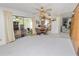 Open living room and dining room featuring a ceiling fan, sliding glass doors, and wood paneled wall at 2167 Timber Ln, Clearwater, FL 33763