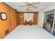 Large living room with paneled wall, ceiling fan, and sliding doors providing lots of light at 2167 Timber Ln, Clearwater, FL 33763